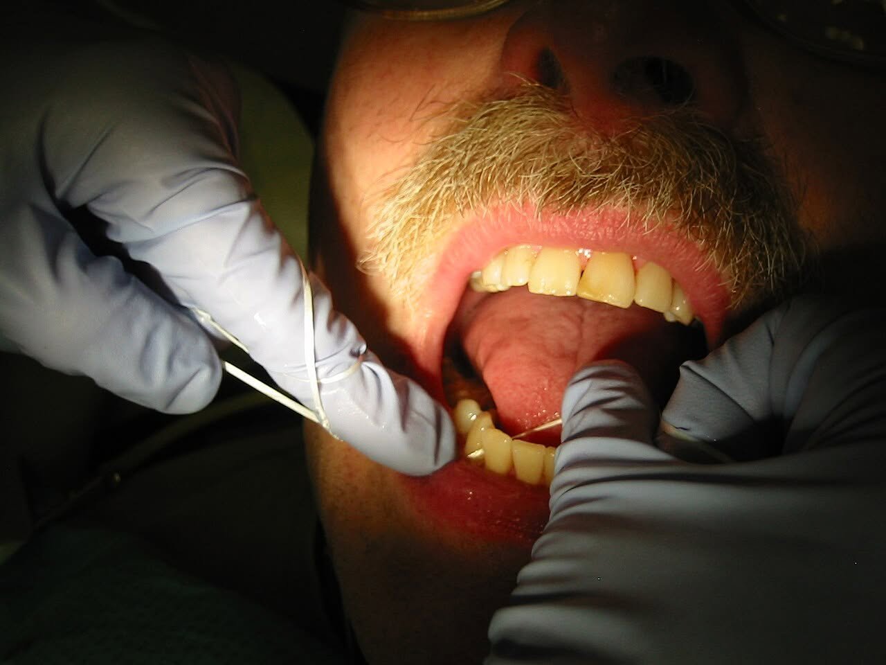 Person flossing teeth
