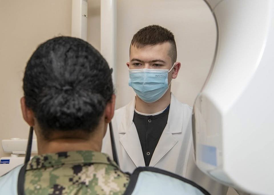 Dentist preparing a dental X-ray to check for an abscess