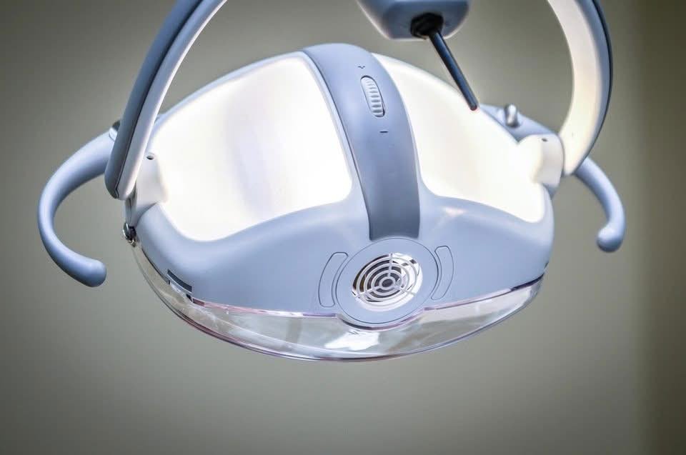 Dental operating light above the treatment chair, where tooth nerve problems are diagnosed